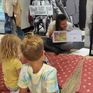 Staff member reading to children